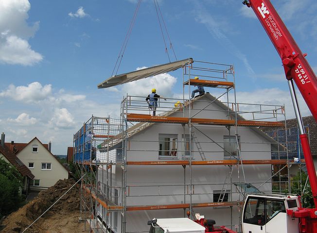 house construction surrounded with scaffolds