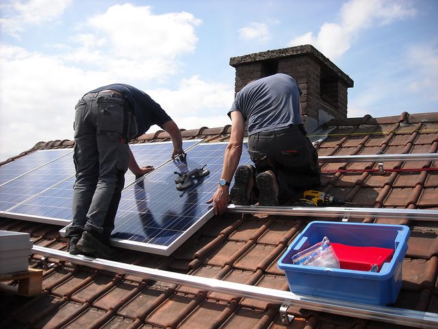 two men installing solar panels